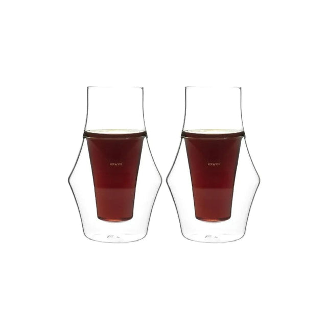 Two Kruve EQ Inspire double-walled glass cups, each 150ml, filled with dark liquid, likely coffee, have a transparent curvy design with a narrow middle section to enhance flavor and maintain an even level.