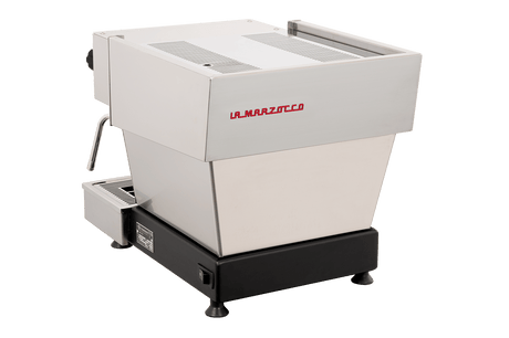 The La Marzocco Linea Mini R Dual Boiler Semi-Automatic Espresso Machine in brushed stainless steel rests on a sleek black base, showcasing a left-side steam wand and a minimalist, modern design set against a plain white background—an ideal choice for aspiring home baristas who want commercial-grade performance.