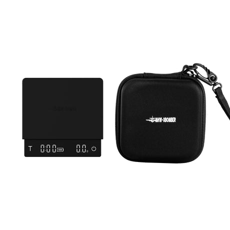 The MHW-3BOMBER Espresso Ready Travel Kit Bundle features a compact black scale with display and a matching zippered case with wrist strap—both sporting white MHW-3BOMBER logos, perfect for espresso at home or on the go.
