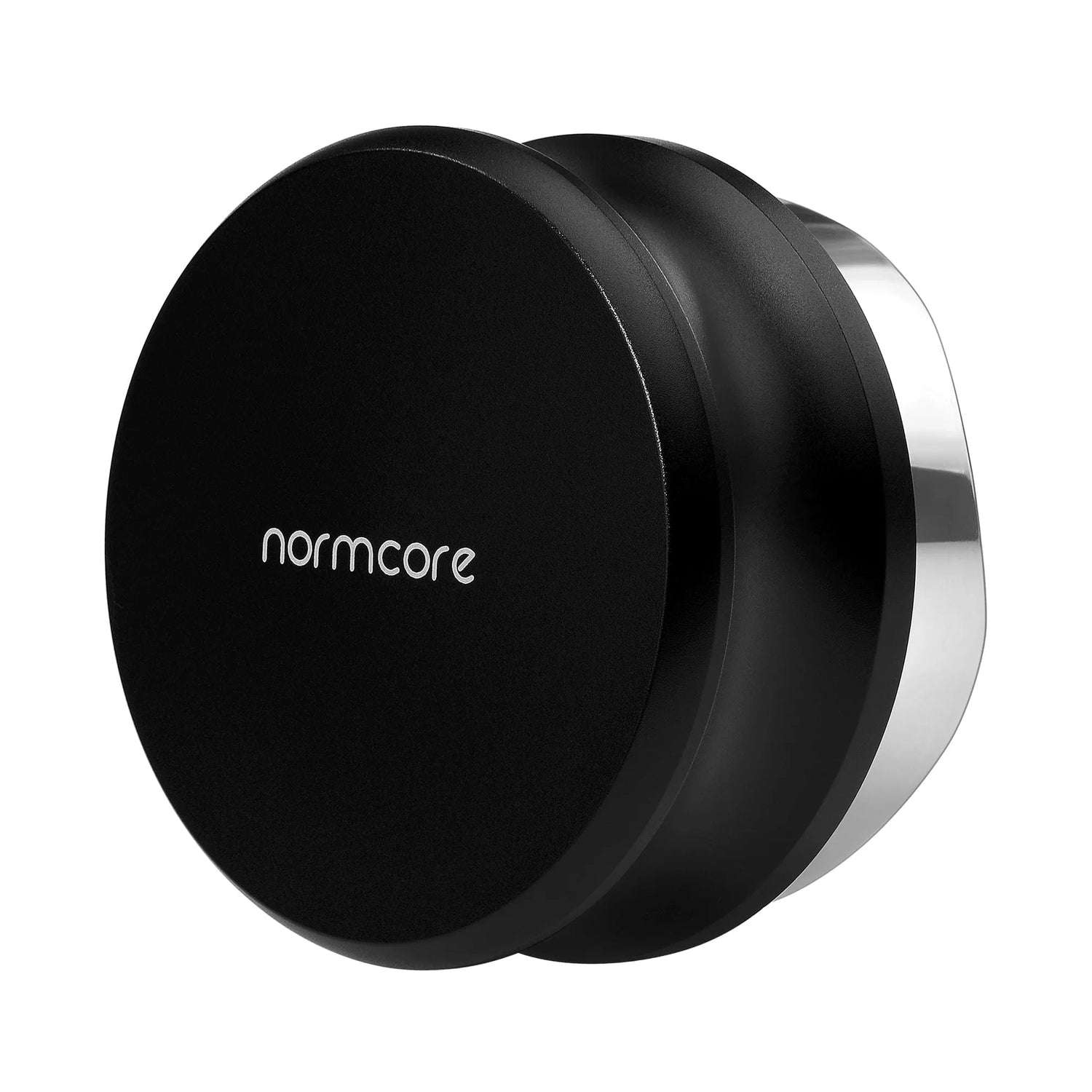 The Normcore Gravity Distributor Tool (58.5mm) by Normcore is a black metal coffee distribution accessory, distinguished by its round flat top and metallic edge with the brand name “normcore” inscribed on it. Displayed against a white background, this gravity distributor tool is designed specifically for 58.5mm portafilters to ensure even and consistent coffee grounds, helping you achieve the perfect espresso shot every time.