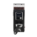 The Rancilio Stile SD Espresso Coffee Grinder (Black) by Rancilio features flat burrs, a digital display, and a portafilter holder, shown filled with coffee beans.