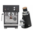 The Profitec Move Dual Boiler Espresso Machine (Black) and DF54 Grinder (Black) Bundle by Profitec features a sleek, compact espresso machine crafted from stainless steel with refined wooden accents, paired with a matching black electric grinder that boasts a wooden-topped lid and transparent grounds container—bringing professional-quality espresso to any kitchen.