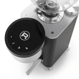 A close-up of the Rocket Giannino Coffee Grinder R01RG099B3A12 by Rocket shows its sleek black and stainless steel design, micrometric grind adjustment, a digital interface with illuminated touch controls, and a prominent "R" logo.