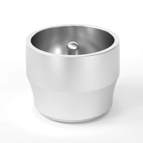The Weber Workshops Blind Shaker (Silver) is a metallic, cylindrical espresso prep tool with a smooth silver finish and center bump at its base—ideal for barista-quality results—shown on a plain white background.