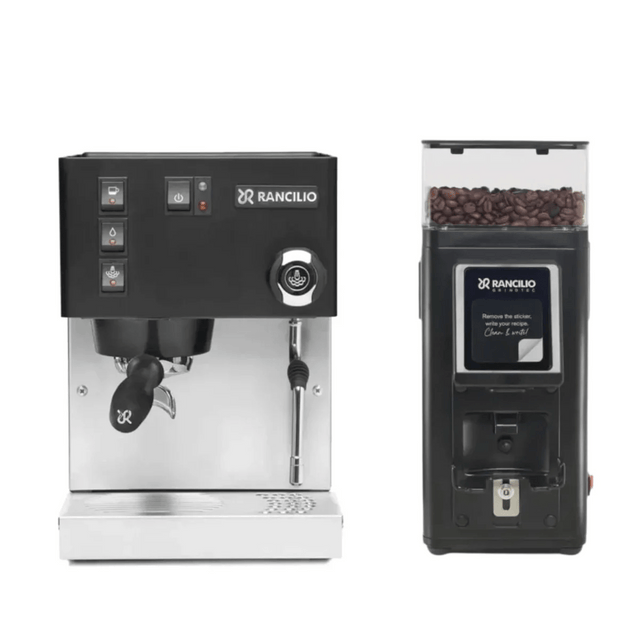 The Rancilio Silvia M V6 Espresso Machine (Limited Edition Black and Stainless Steel) and the Rancilio Stile SD Grinder, both by Rancilio, are displayed side by side against a white background. The grinder is filled with coffee beans.