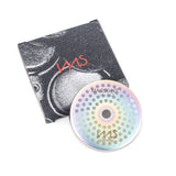 A precision shower screen by IMS, measuring 56.5mm and part of the MA 200 NT series, is labeled "IMS" and displayed next to its black and white sleeve, which shows a partial image reminiscent of stainless steel photoetching with the "IMS" logo.