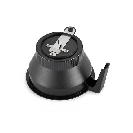 A black, dome-shaped Moccamaster CDT Grand pencil sharpener with a base that includes an attached handle for stability. The sharpener features a metal blade on top and a small looped handle. The background is white.