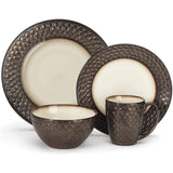 The Cuisinart 16 Piece Dinnerware Set (CDST1-S4G1C) by Cuisinart features a matching 4-piece set that includes a large dinner plate, a smaller salad plate, a bowl, and a mug. Crafted from Anais glazed stoneware, each piece boasts textured dark brown exteriors resembling scales and smooth, light cream interiors with a gradient brown edge.