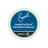 A Keurig K-Cup® pod labeled "Emeril's Decaffeinated Jazzed Up." The label showcases dark blue and green colors with white and teal text, prominently featuring the Keurig and recycling symbols at the bottom, making it ideal for enthusiasts of dark roast decaffeinated coffee.