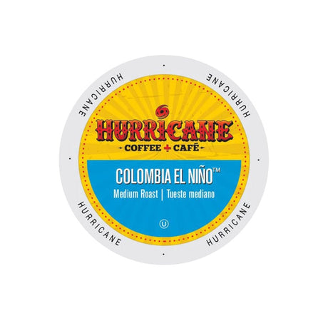 A circular label for the Hurricane Coffee Colombia El Niño Single-Serve Pods (Case of 96) features a sunburst design with the brand "Hurricane Coffee + Café." The text reads "Colombia El Niño, Medium Roast, Tueste mediano," and the border is adorned with the word "Hurricane" repeated around the edge.