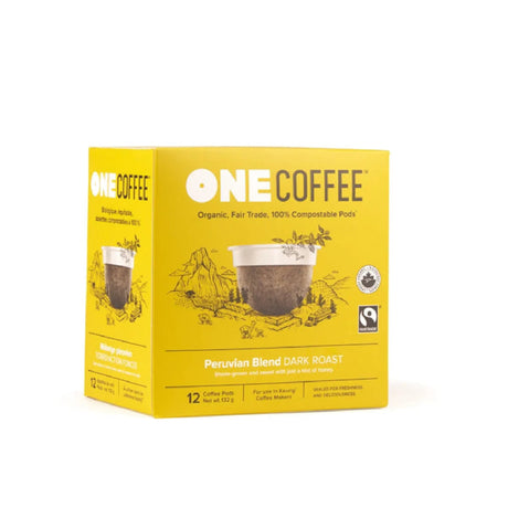 A box of OneCoffee Peruvian Single-Serve Pods, featuring Certified Organic Dark Roast Coffee, highlights that the coffee is fair trade and 100% compostable. The yellow box, which contains 18 single-serve pods, includes images of mountains and coffee cups.