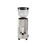 A front view of the Profitec Pro M54 Coffee Grinder by Profitec in silver, featuring a transparent bean hopper on top. The small grinder includes stepped setting controls, a rectangular stainless steel body, and two small black feet at the bottom for stability.