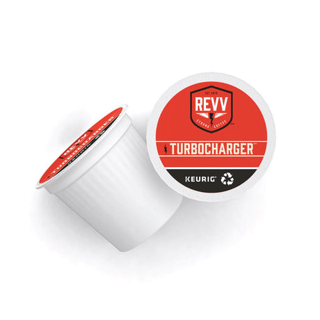 A single-serve K-Cup® Pod labeled "REVV® TURBOCHARGER" by REVV is shown. The top of the pod is red with white and black accents, displaying a shield logo and lightning bolt graphic. Ideal for Keurig Brewers, this Dark Roast pod has a white base and comes from a box of 24 pods.