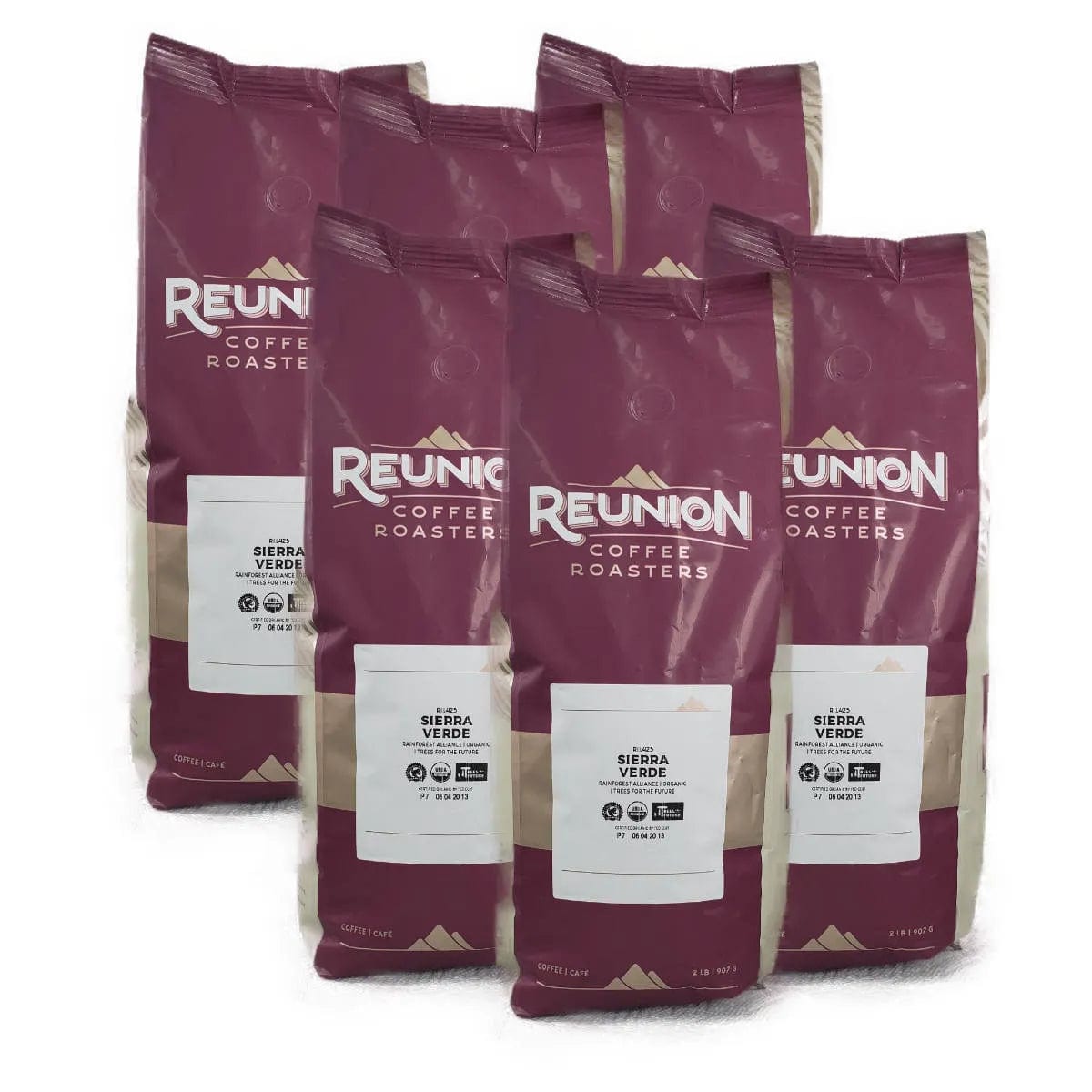 Six maroon and beige bags of Reunion Island Sierra Verde Whole Bean Coffee from Reunion Coffee Roasters are standing upright. Each bag features the Reunion Coffee Roasters logo along with labeling that details the flavor, Fair Trade Certified status, and other coffee specifics.