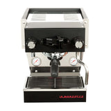 The La Marzocco Linea Micra Espresso Machine (Black) boasts a sleek stainless steel and black design. This machine features a portafilter, two pressure gauges, and a steam wand to ensure café-quality drinks. The drip tray is located at the bottom front, with "La Marzocco" displayed in bold red letters.