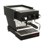 The La Marzocco Linea Micra Espresso Machine (Black) with silver accents features dual knobs, a steam wand, and a portafilter. The machine also includes a drip tray and a pressure gauge, with the "La Marzocco" brand name in red on the front lower right corner, ensuring café-quality drinks at home.